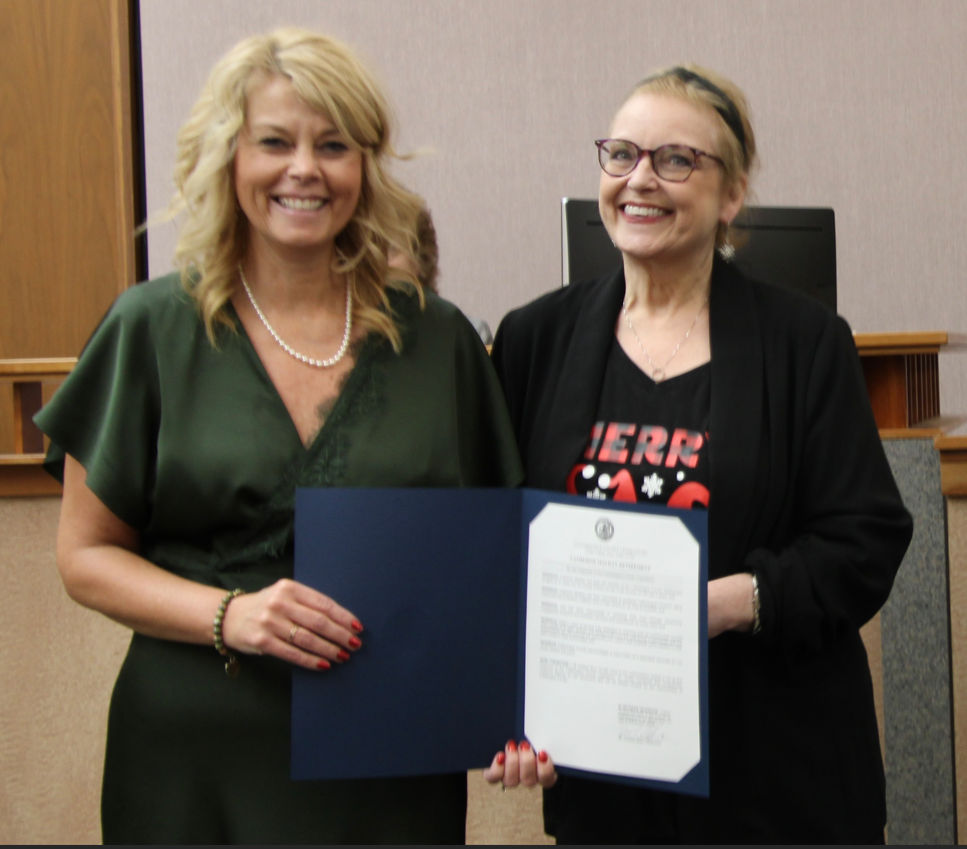 (Rick Miller/Olean Star) Retired Department of the Aging Director Cathy Mackay (center) was honored Wednesday by Cattaraugus County lawmakers with a proclamation and an engraved gift. At left is Human Services Committee Chairman Kelly Andreano and Legislature Chairman Andrew Burr is at right.