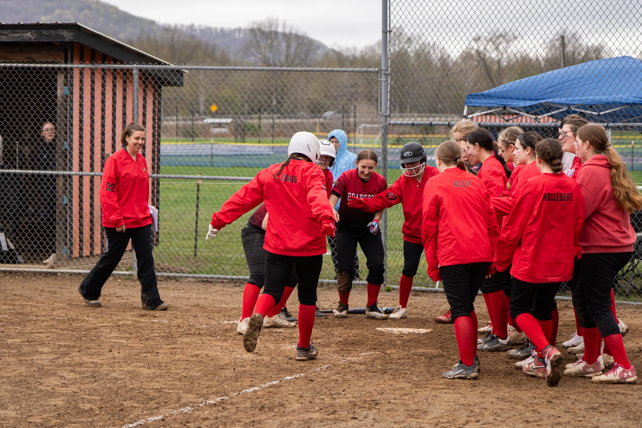 Bradford's Mallory Craig is welcomed at home plate after smashing a three-run homer during the Lady Owls' win over Port Allegany. Craig ended with three RBIs and two runs on a 2-for-4 day at the plate. | Photo by Hunter O. Lyle