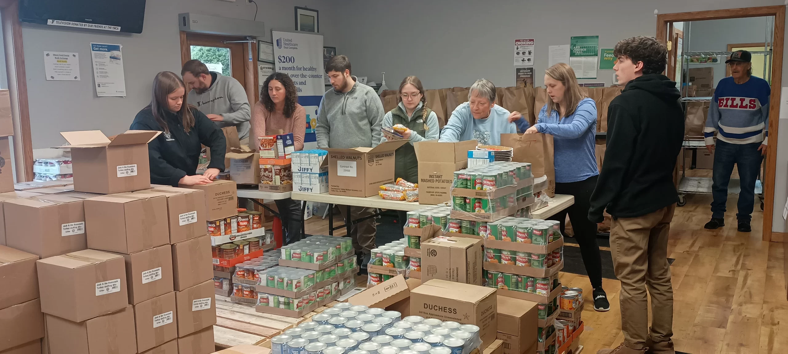 (Photo submitted) Olean Food Pantry volunteers sort canned goods for distribution at the 8 Leo Moss Drive facility in Olean.