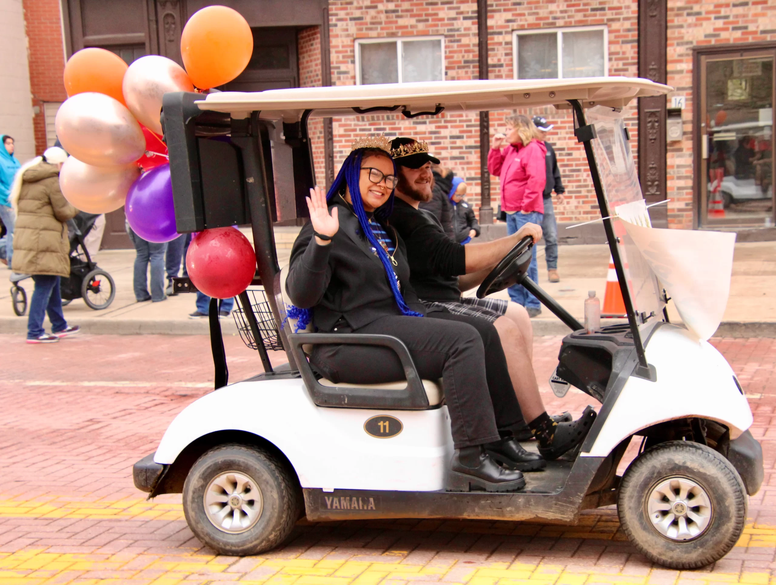 (Rick Miller/Olean Star) Maple Queen Elizabeth Price and Maple King Shea Smith, ride in the Maple Parade in a golf cart.