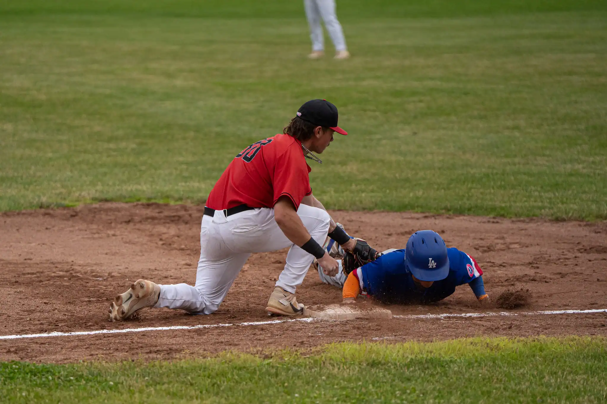 Oilers' first baseman Chase Fischer attempts to catch a Rapids' baserunner off guard with a tag out during Olean's second loss of the season. | Photo by Hunter O. Lyle