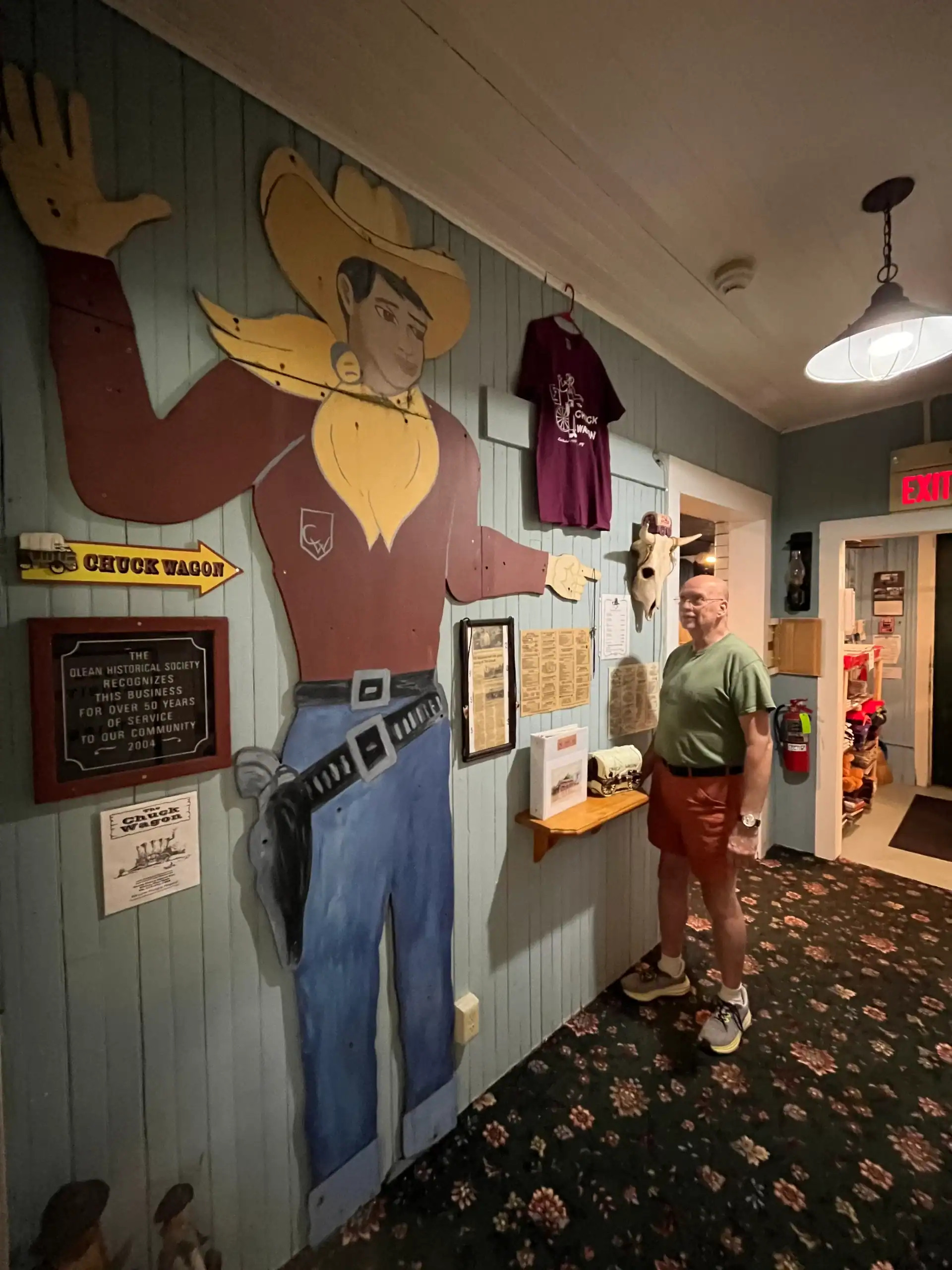(Rick Miller/Olean Star) Olean Historical and Preservation Society president Steve Teachman stands next to the Chuck Wagon Cowboy, the outdoor advertising figure that used to stand the iconic Olean restaurant on Route 16. It is now on permanent display at the Olean Point Museum.