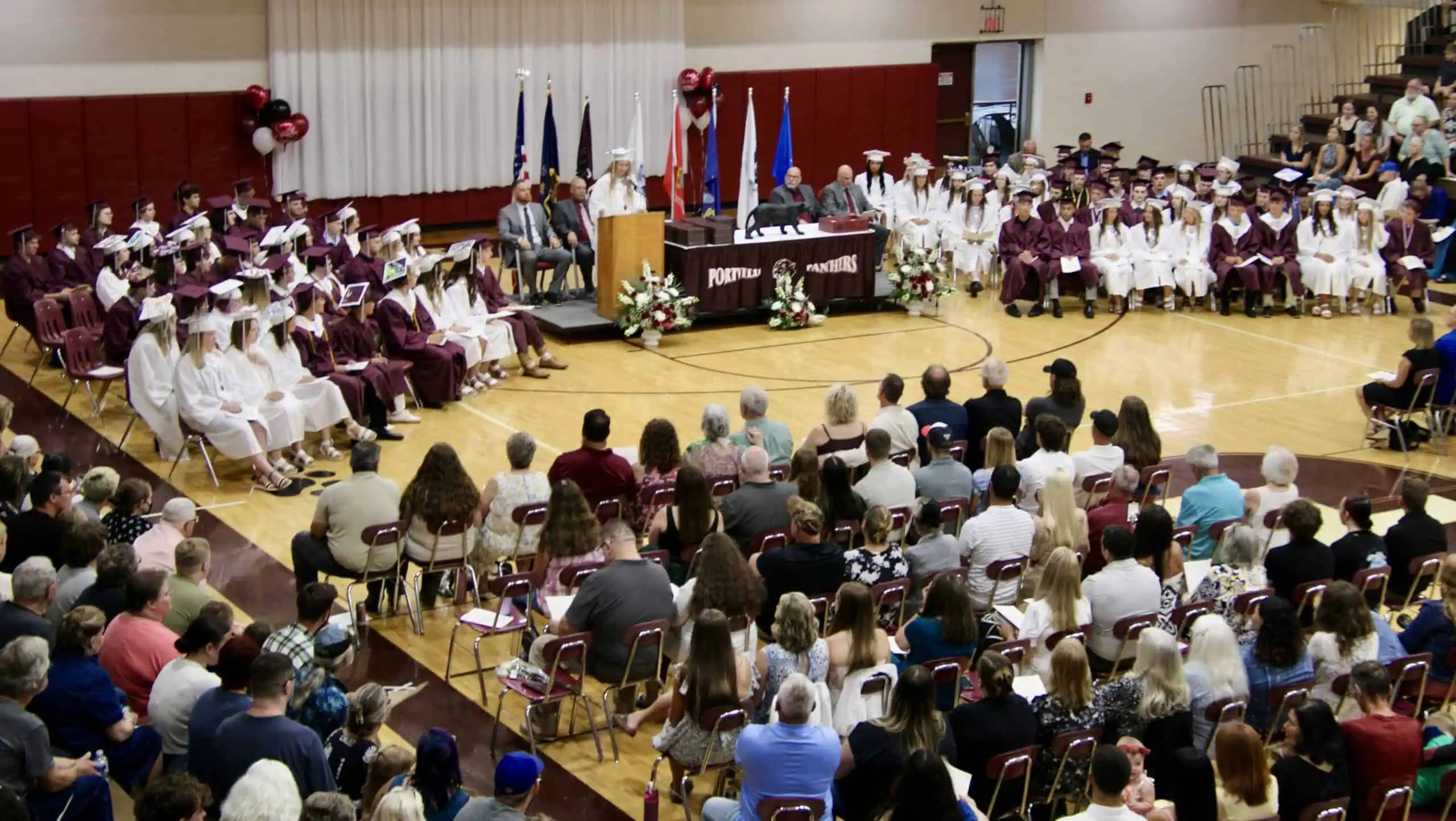 (Rick Miller/Olean Star) Portville Senior Class President Zya Rayne DeGolier addresses her classmates and family and friends attending commencement exercises Friday evening in the school gymnasium.