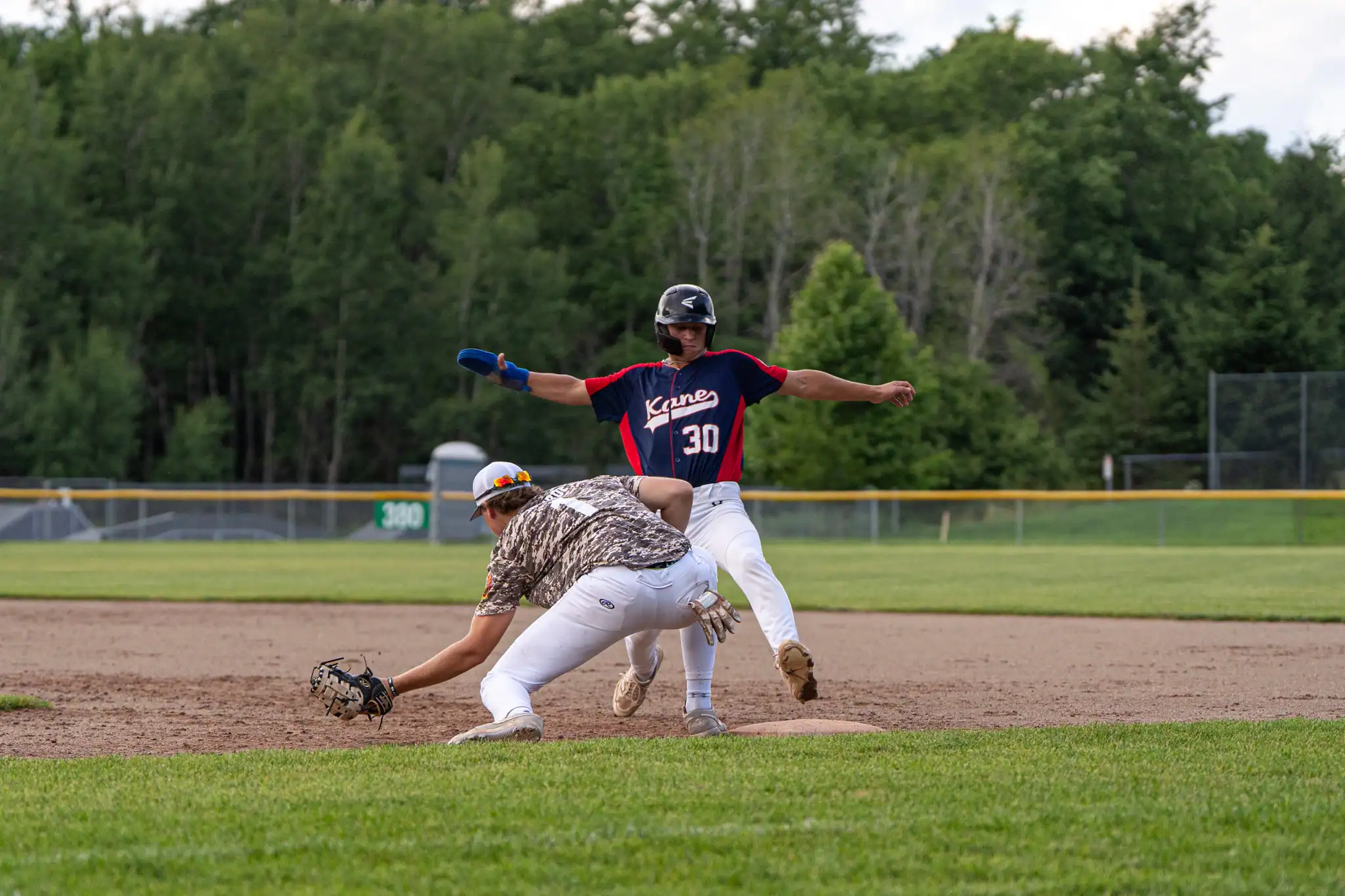 Kane's Phinn Chamberlain (30) beats an attempted tag out at first during Bradford Legion's 6-1 loss on Tuesday. | Photo by Hunter O. Lyle