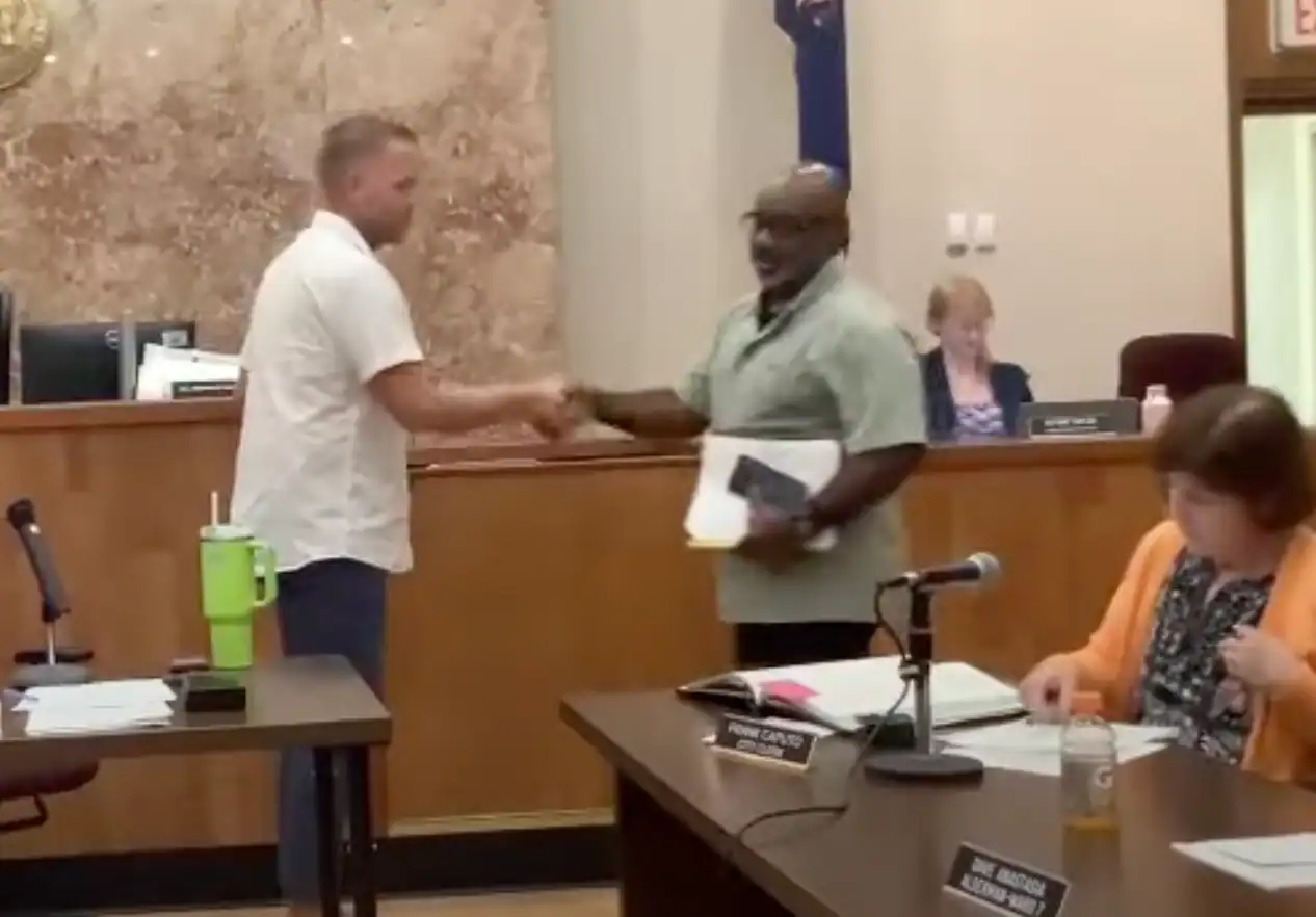 (City of Olean YouTube) Outgoing Olean Common Council President John Crawford (left) hands gavel to Ward 6 Alderman Vernon Robinson Jr., who was elected the first Black common council president. Crawford has taken a new job and stepped down as council president, but will continue as Ward 5 alderman.