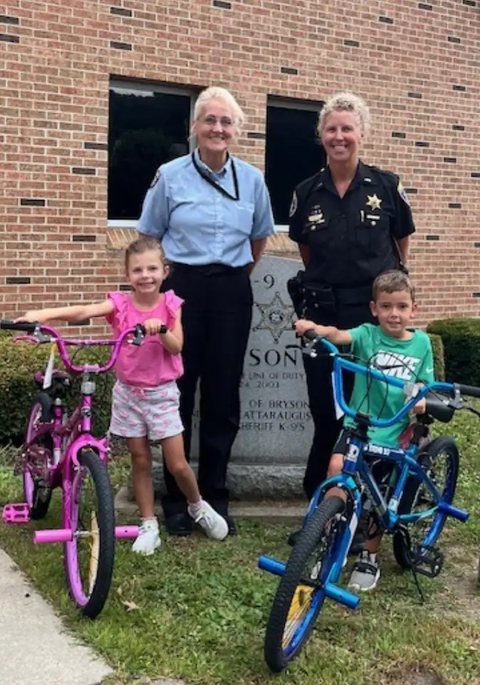 (Photo provided) Winners of this year’s Cattaraugus County Sheriff’s Office bike raffle at the county fair are Layla Farnum, 6, of Randolph (left) and Hudson Congdon, 5 of Randolph. Standing behind the winners are Sheriff’s Benevolent Association Secretary Karla Hanft (left) and Administrative Lieutenant Melanie Churakos of the Sheriff’s Office.