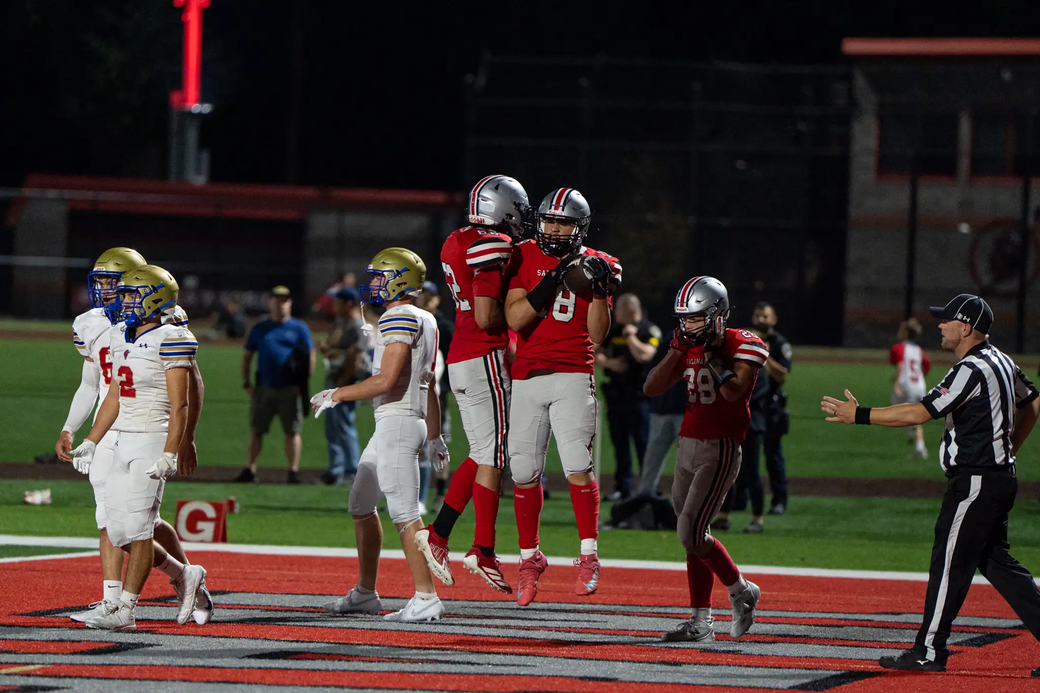 Salamanca's Camron Bowser (right) celebrates with Thomas George after coming down with a touchdown reception during the Warriors' win over Falconer. | Photo by Hunter O. Lyle