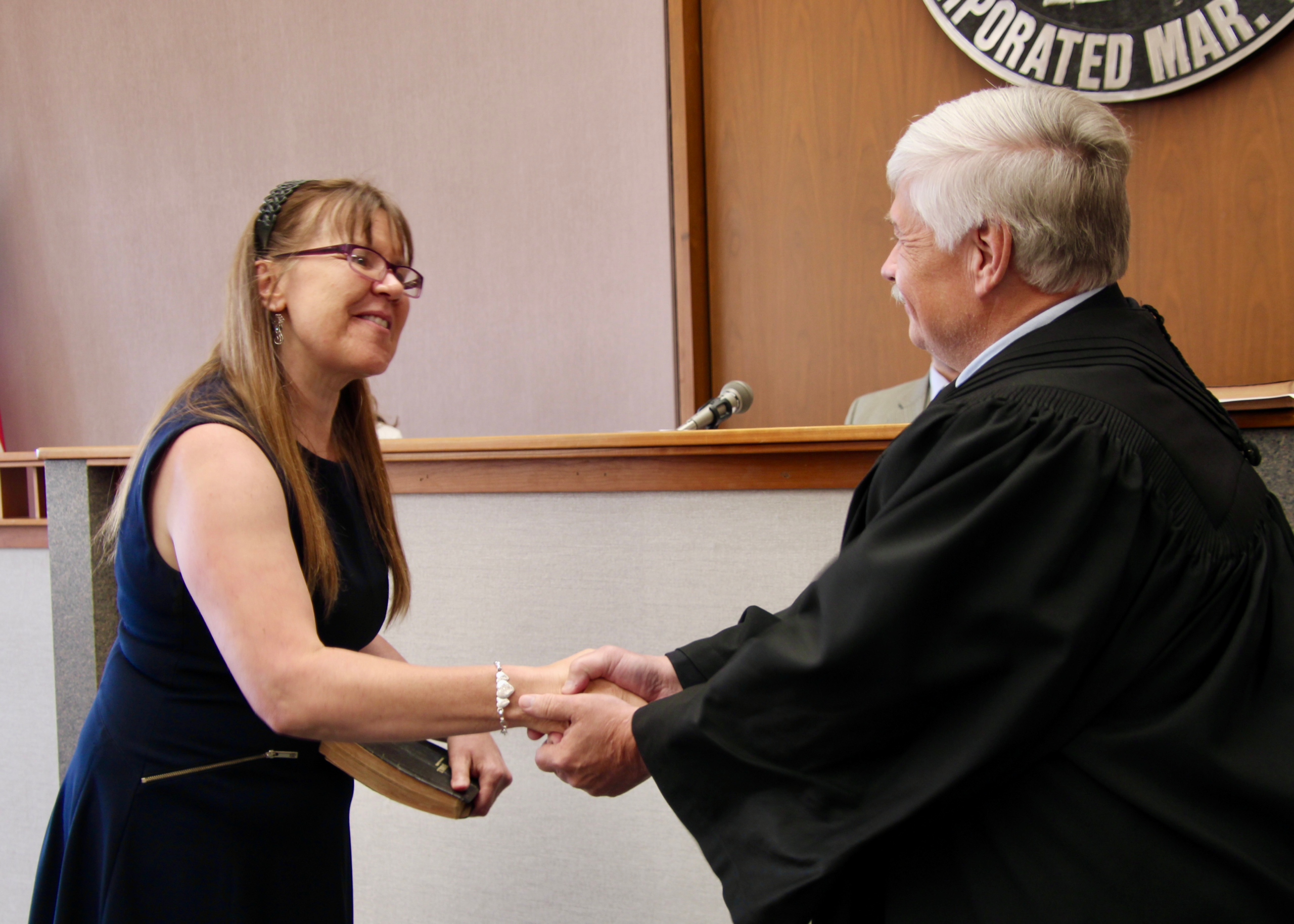(Rick Miller/Olean Star) New Cattaraugus County Legislator Brenda Hansen of Delevan is congratulated by Cattaraugus County Court Judge Ronald Ploetz after she was sworn in Wednesday.