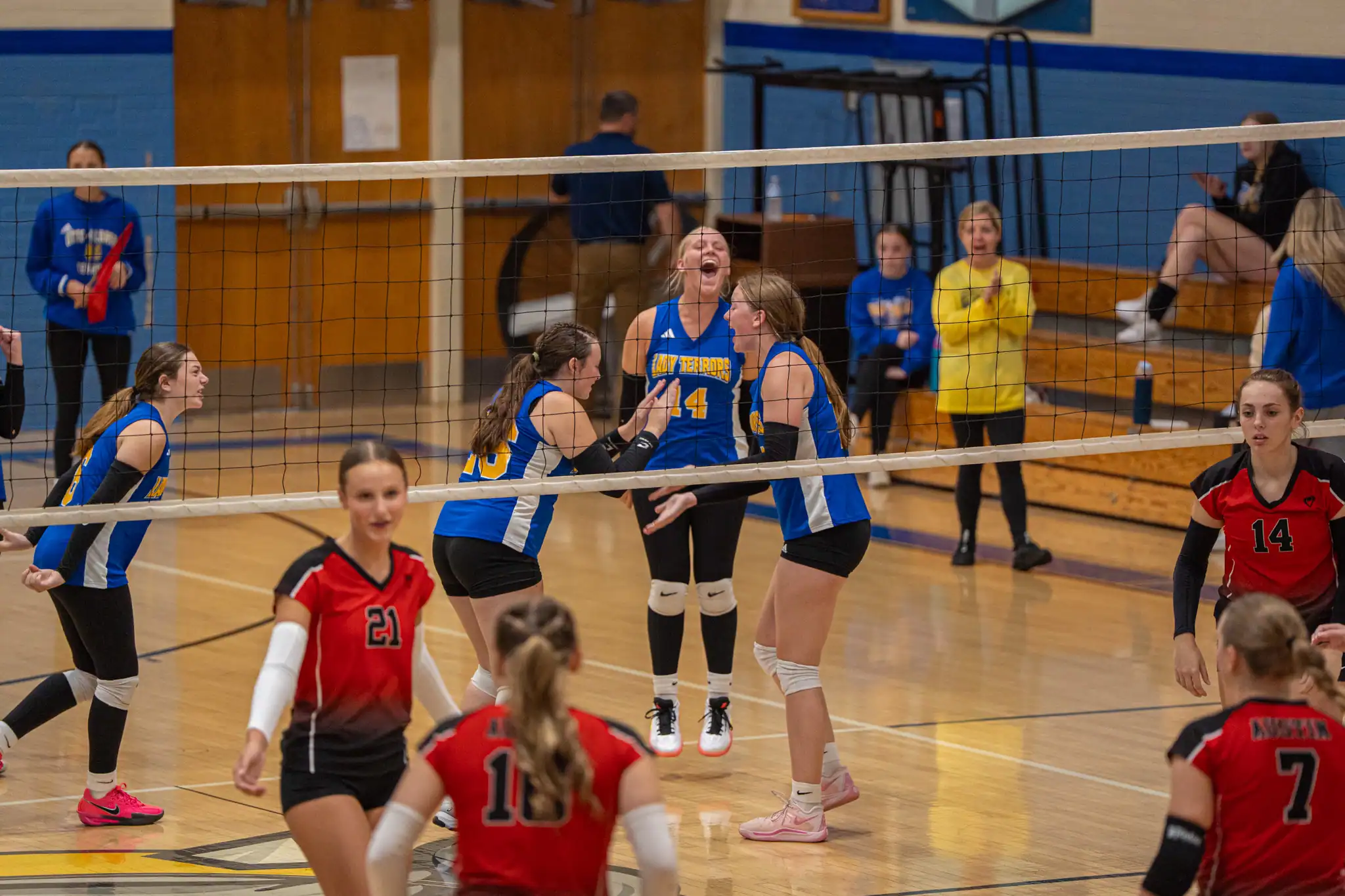 The Otto-Eldred volleyball team celebrates after sealing their third set win and sweep of Austin on Tuesday. | Photo by Hunter O. Lyle
