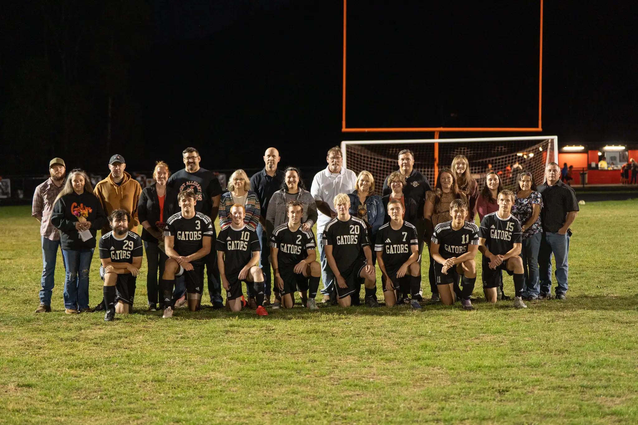 At halftime of the Gators' meeting with Coudersport, Port Allegany honored their eight seniors. Pictured here with their family is Owen Erhard (front row, left to right), Jarrod Funk, Trey Kiser, Owen Kisler, Micah Emerick, Alex Schott, CJ Bridenbaker and James Nichols. | Photo by Hunter O. Lyle
