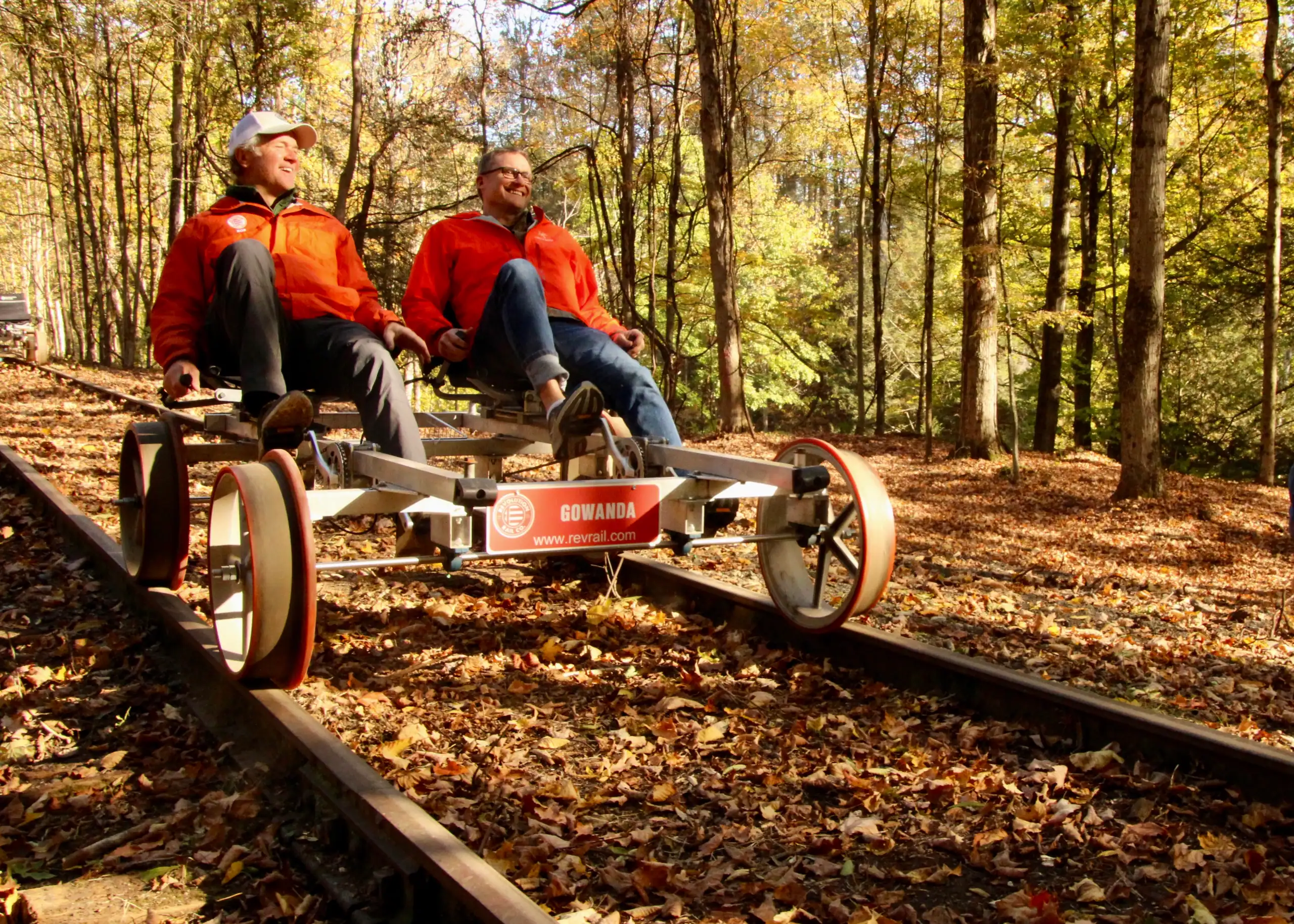 (Rick Miller/Olean Star) Revolution Rail CEO Rob Harte (left) and Rocketcup Coffee CEO Tom Cullen ride a rail bike along railroad tracks of the former Erie Railroad near Cattaraugus Thursday. There will be pop-up rail bike rides on the next three weekends in Cattaraugus.