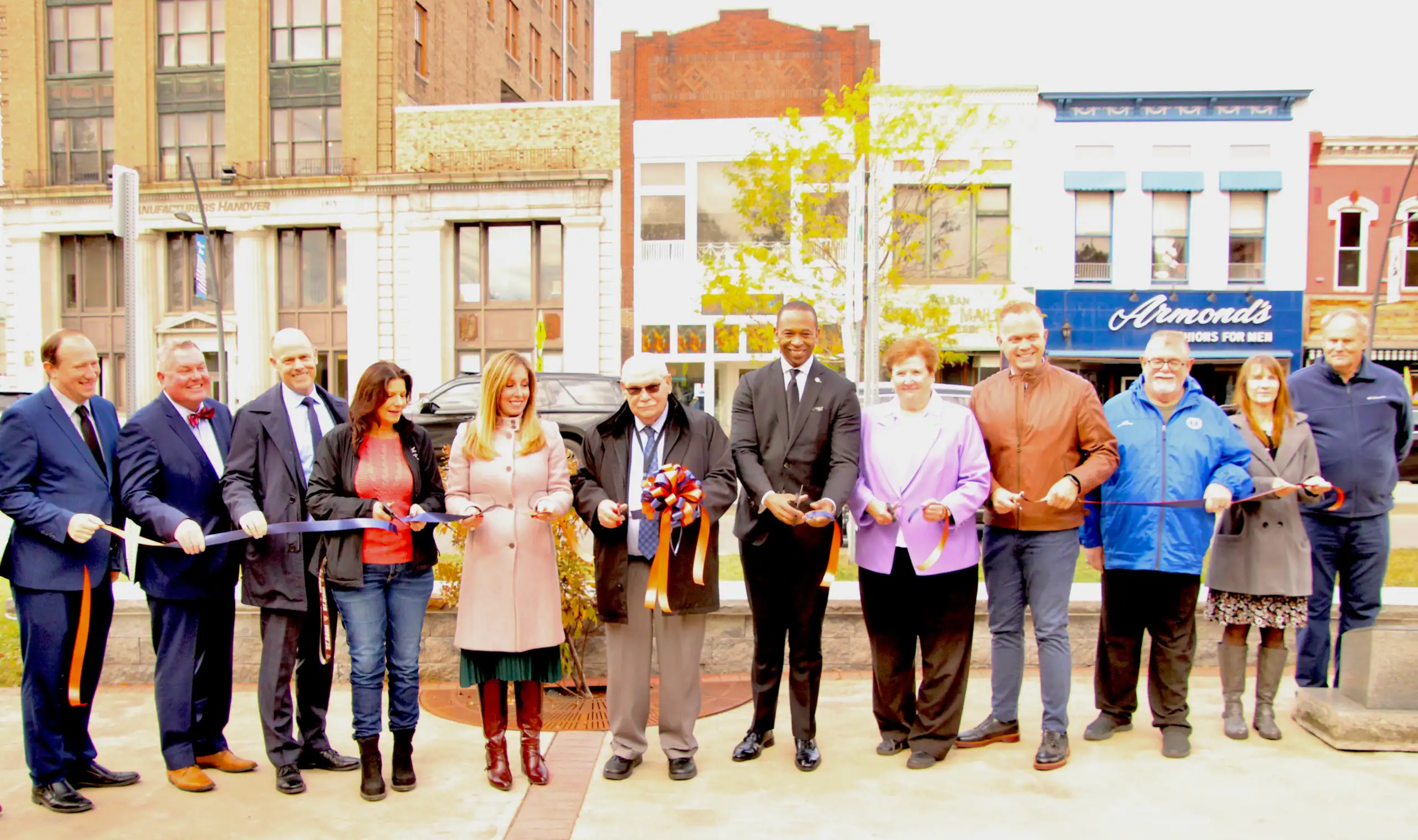 (Rick Miller/Olean Star) Olean Mayor Bill Aiello and New York Secretary of State Walter T. Mosley cut the ribbon Friday signaling the completion of the original $10 million Downtown Revitalizatiion Initiative that included reimagining North Union Street. Recent South Union Street and East State Stret projects have also been completed.
