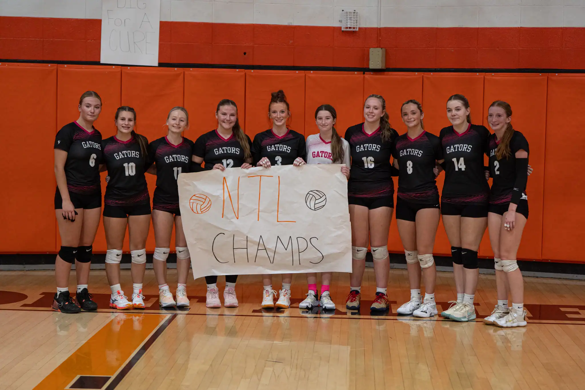 After defeating Otto-Eldred, the Port Allegany volleyball team raised their impromptu North Tier League Champion banner. | Photo by Hunter O. Lyle
