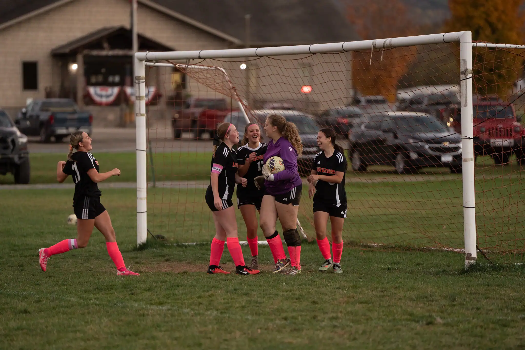 The Port United soccer team celebrates with goalkeeper Hannah Taylor who came away with a game-saving block in the final two minutes of Port United's double-overtime draw with the Lady Crusaders. | Photo by Hunter O. Lyle