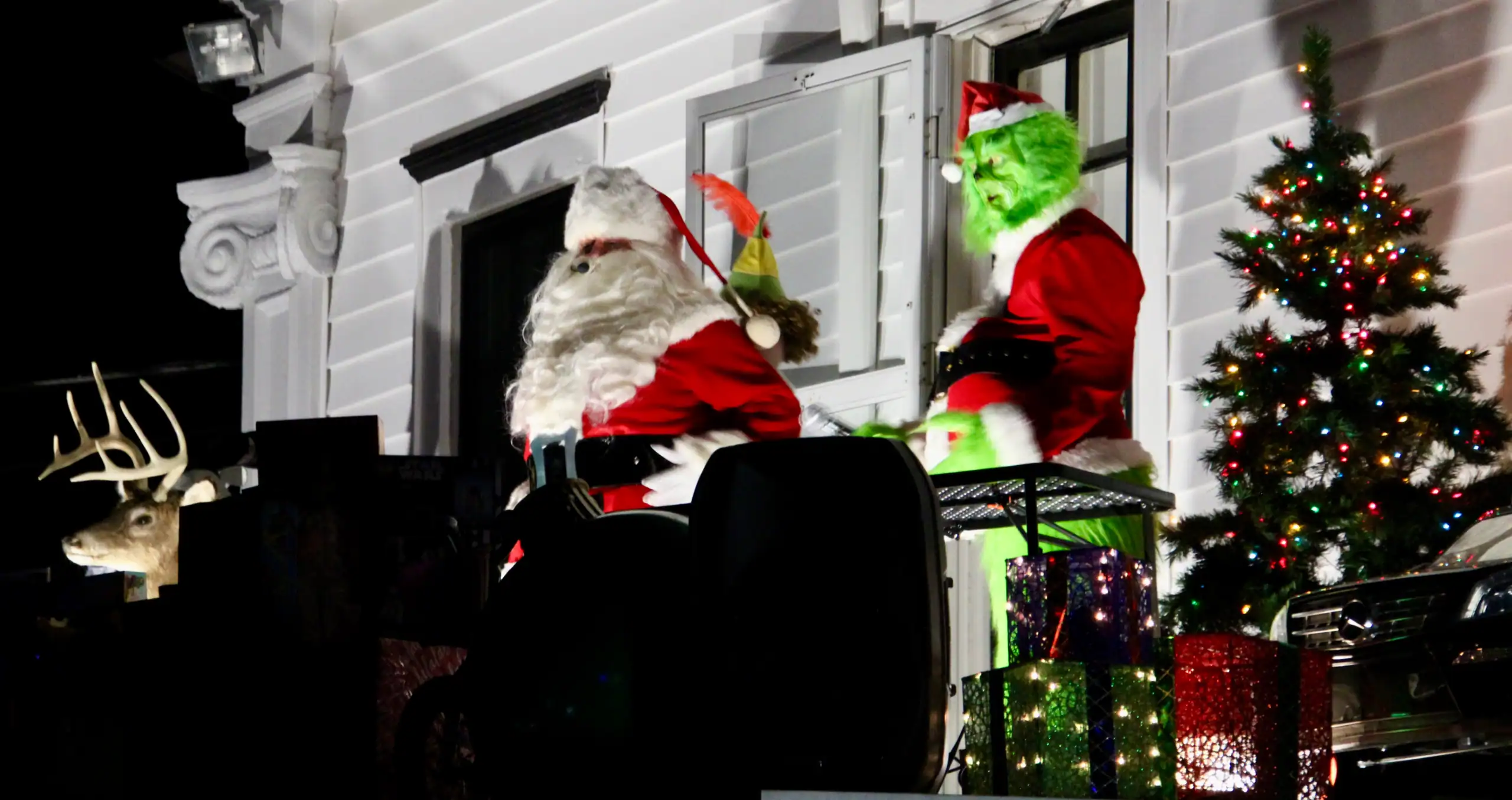 (Rick Miller/Olean Star) Santa Claus and a specisl guests, including The Grinch, appeared on the rooftop at 660 Main St. Saturday night in Olean.