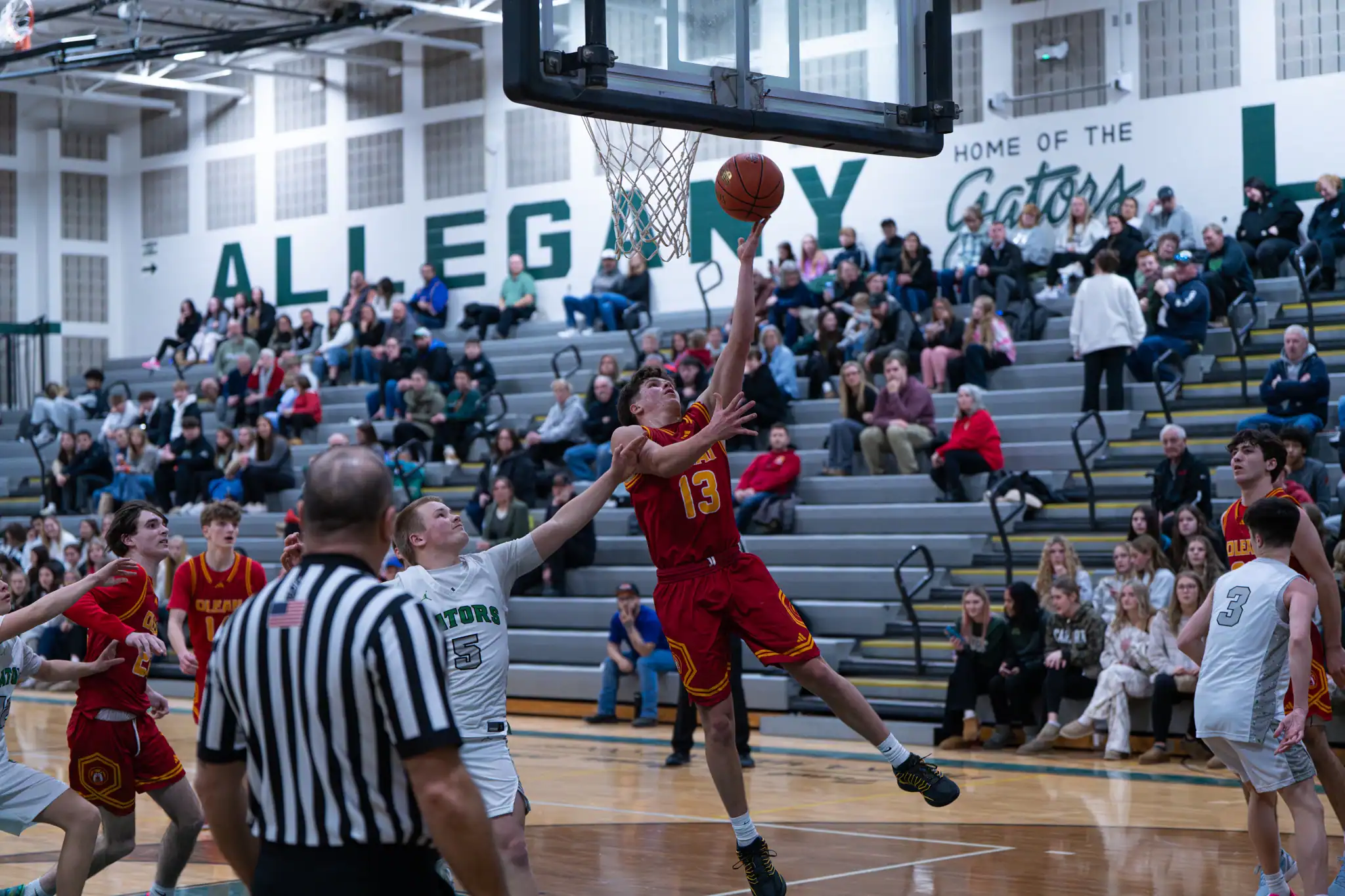 Olean's Adrian Bohdanowycz drives to the rim despite taking contact along the way during the Huskies' blowout win over Allegany-Limestone | Photo by Hunter O. Lyle