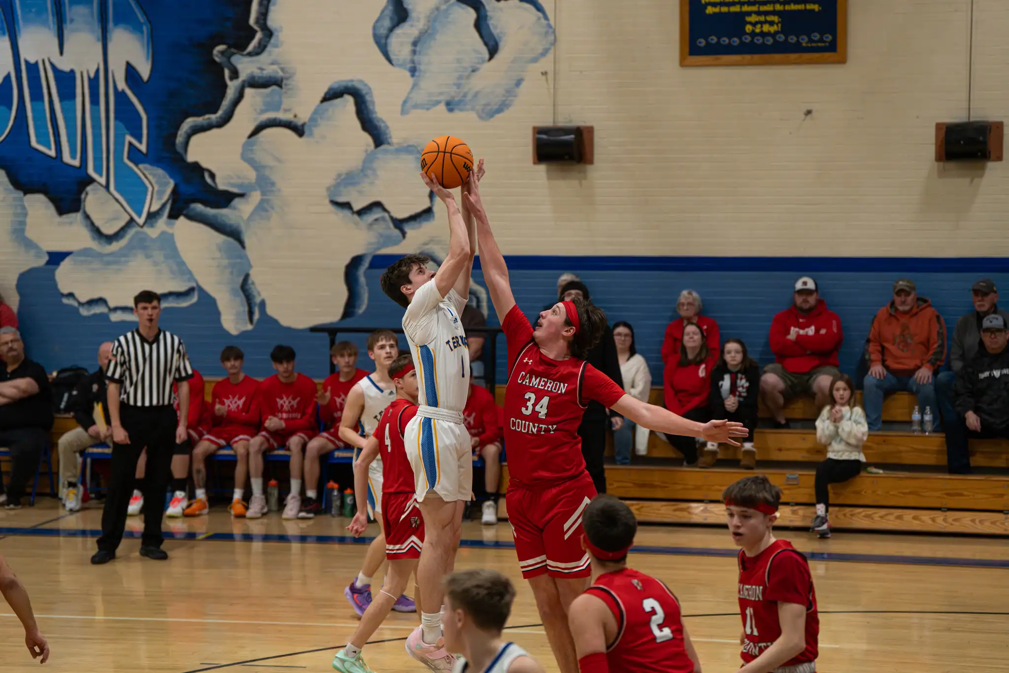 Cameron County's Isaac Grovanz (34) smothers Wyatt Blendinger (1) as he attempts to get off a shot in the Terrors' loss to the Red Raiders on Thursday. | Photo by Hunter O. Lyle