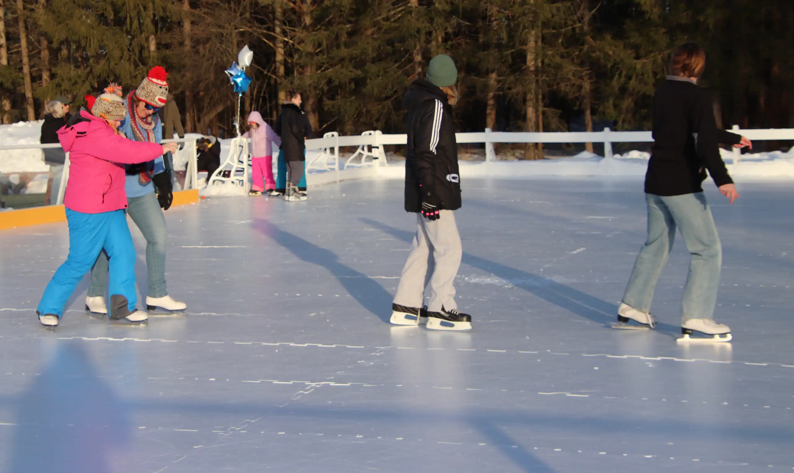 (Rick Miller/Olean Star) A group of people skate on the synthetic ice surface at the Bill Flanigan Memorial Ice Pond, where a grand re-opening and ribbon cutting were held Friday in Salamanca.