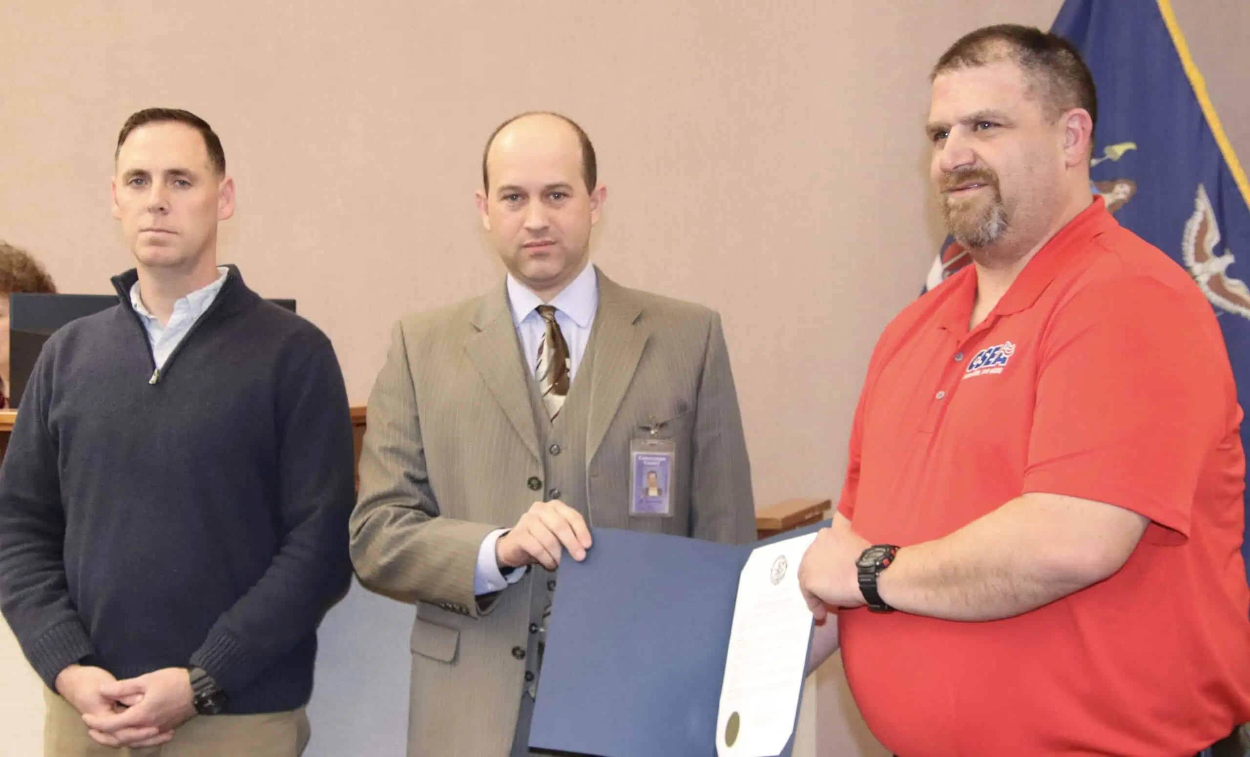 (Rick Miller/Olean Star) Adam Chudy (right) of Westons Mills, was commended by Cattaraugus County Legislature Chairman Andrew Burr (center) Wednesday for saving a New Albion man from a fire Feb. 11. Chudy, a count snowplow driver, was working when he saw the house on fire and called 911 and helped the man from his house. At left is Public Works Commissioner Michael Prinino.
