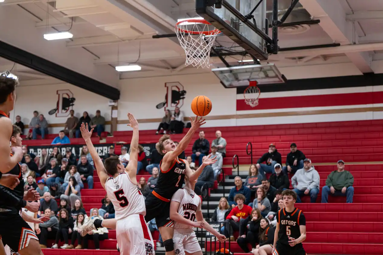Isac Amell tosses up a second-chance shot during the Gators' win over Moniteau. Through four quarters, Amell led the Gators in both points and rebounds, ending with 19 and 14, respectively. | Photo by Hunter O. Lyle