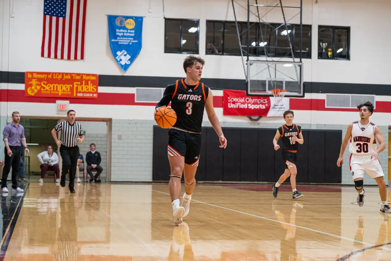 Jarrod Funk carries the ball up the floor during Port Allegany's late scoring run in the fourth. Entering the final eight minutes of play with just a five-point advantage, Funk scored 12 of his 14 points as he carried the Gators to the finish line. | Photo by Hunter O. Lyle