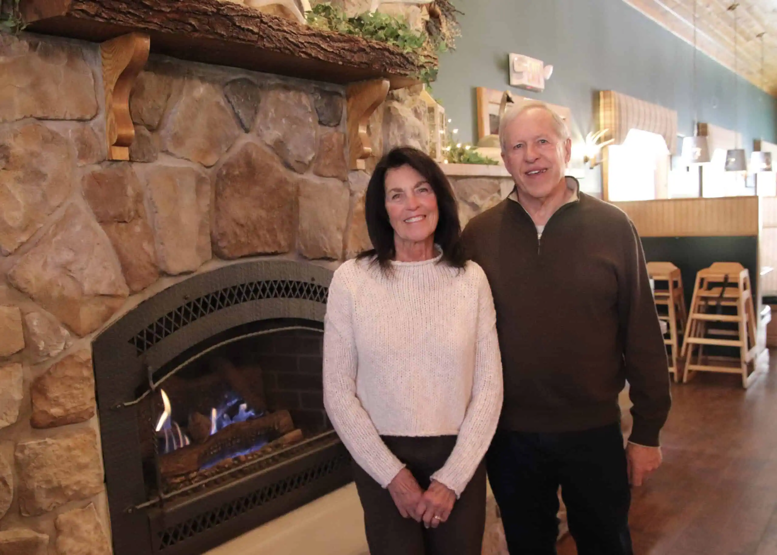 (Rick Miller/Olean Star) Toni and Randy Sprague stand by the fireplace in the restaurant at Sprague's Maple Farms in Portville. They opened the restaurant that features their 100% pure maple syrup and free-range turkeys 25 years ago.