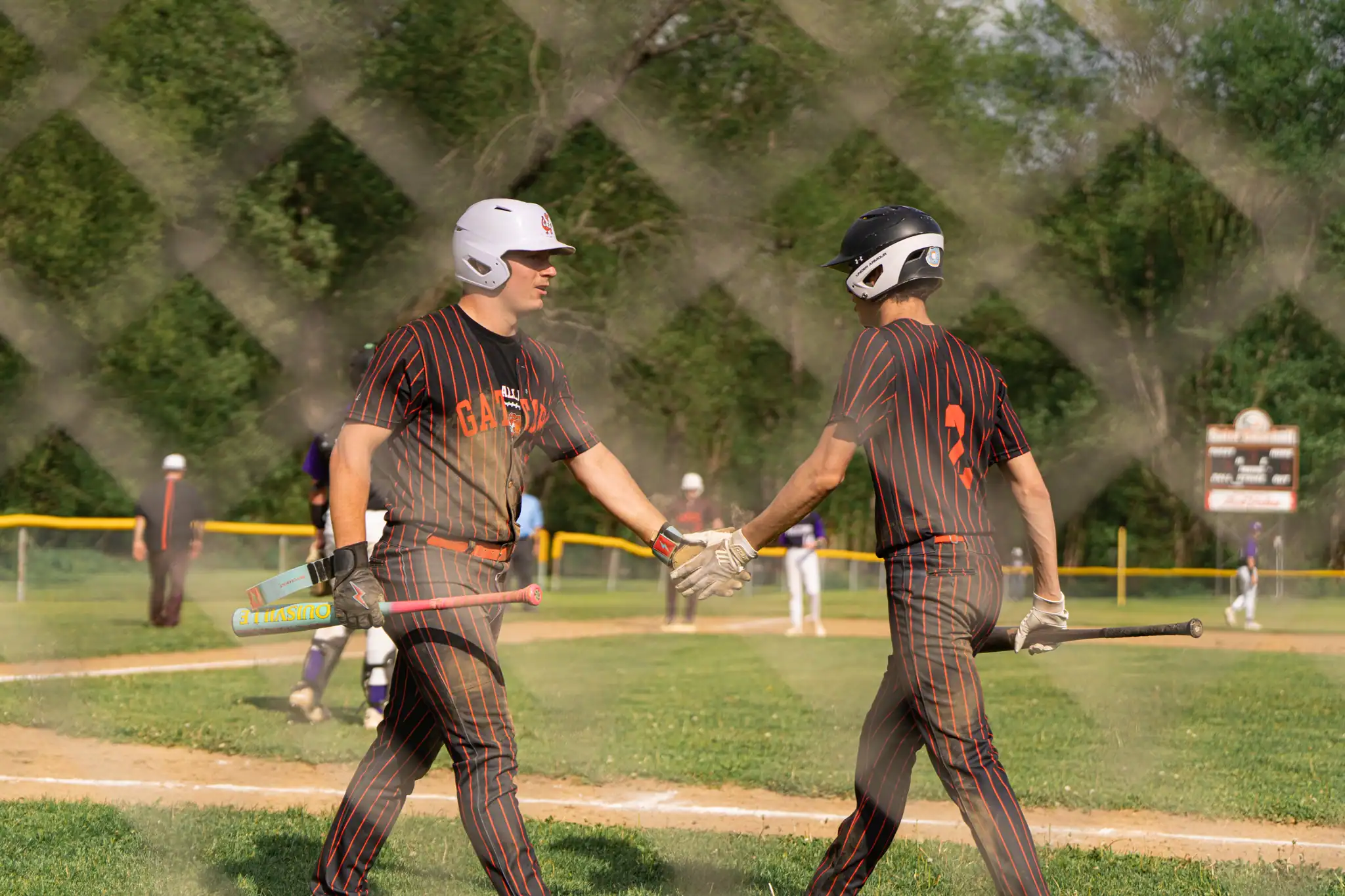 After coming around home plate, Aidan Bliss is welcomed back to the dugout by Liam Hawver during Port Allegany's win over Coudersport in the District 9 Class A quarterfinals. | Photo by Hunter O. Lyle