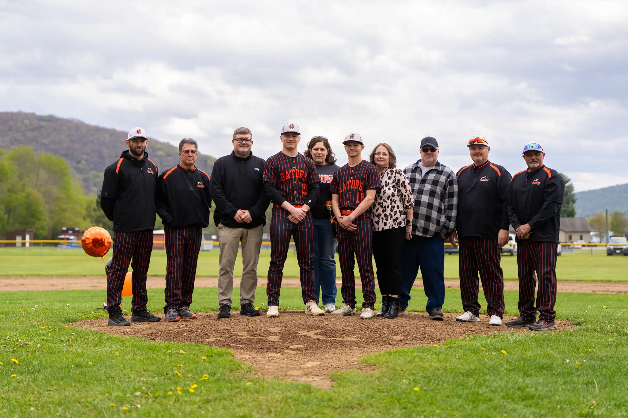 Ahead of the first pitch against Elk County Catholic, the Port Allegany baseball team recognized their two seniors. Pictured here with their family and coaches is Aiden Bliss (front, left) and Nick Wilfong. | Photo by Hunter O. Lyle